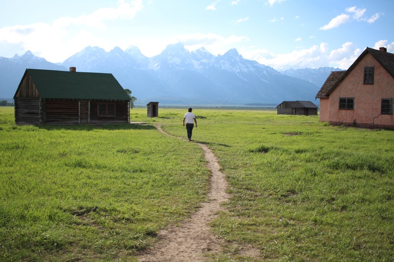 cramped up road trip grand tetons mountain log cabin view